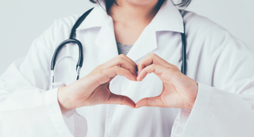 Doctor forming heart shape with hands