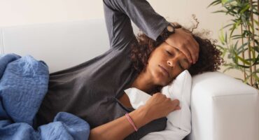 flu clinical trial - woman feeling ill, laid down