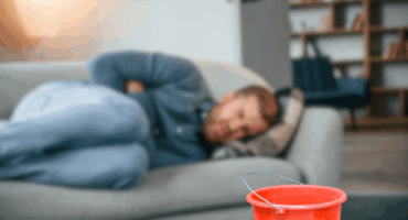 Man suffering with a serious stomach bug infection