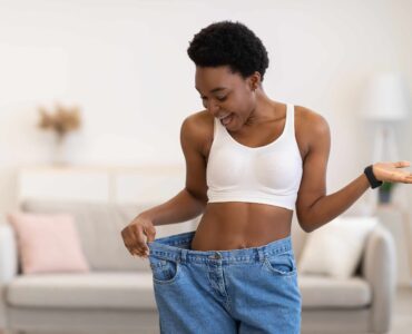 Weight loss - woman experiencing joy through a change in her size