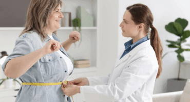 Weight loss - Doctor measuring a patient's waist